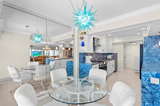 a dining room with furniture and a chandelier