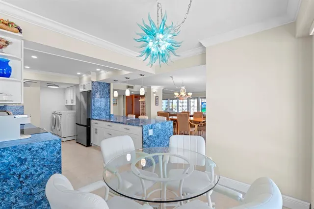 a dining room with furniture and a chandelier