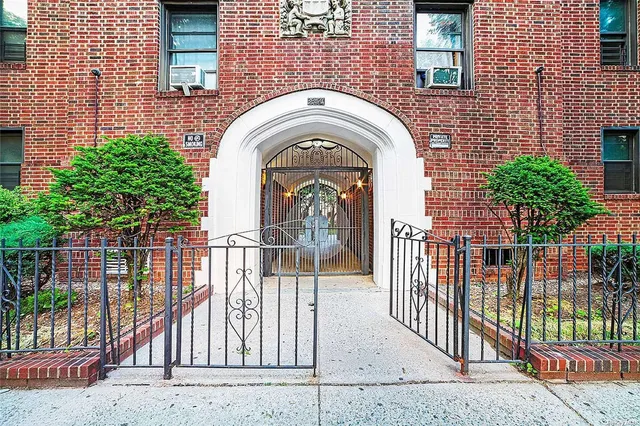 a view of entrance gate of a house with a porch