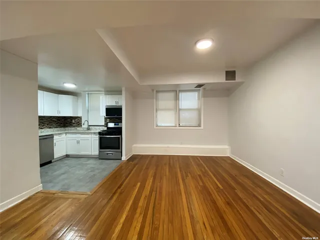 a view of kitchen with wooden floor and electronic appliances