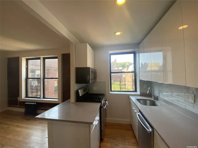a kitchen that has a sink and a stove in it