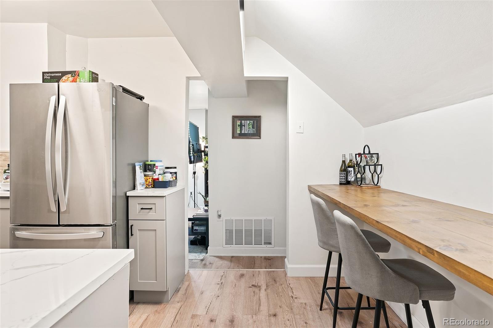 701 Galapago Street Denver, CO 80204 - Photo 17 of 38 a kitchen with stainless steel appliances a refrigerator and a stove top oven