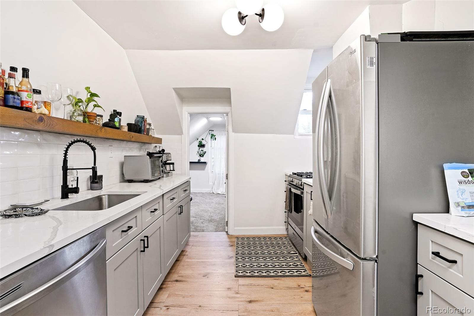 701 Galapago Street Denver, CO 80204 - Photo 18 of 38 a kitchen with sink refrigerator and stove