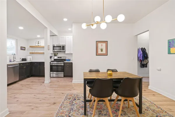 a kitchen with stainless steel appliances kitchen island granite countertop a refrigerator and a sink