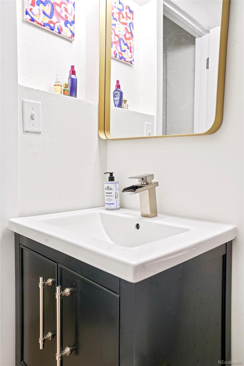 701 Galapago Street Denver, CO 80204 - Photo 10 of 38 a bathroom with a sink and a mirror