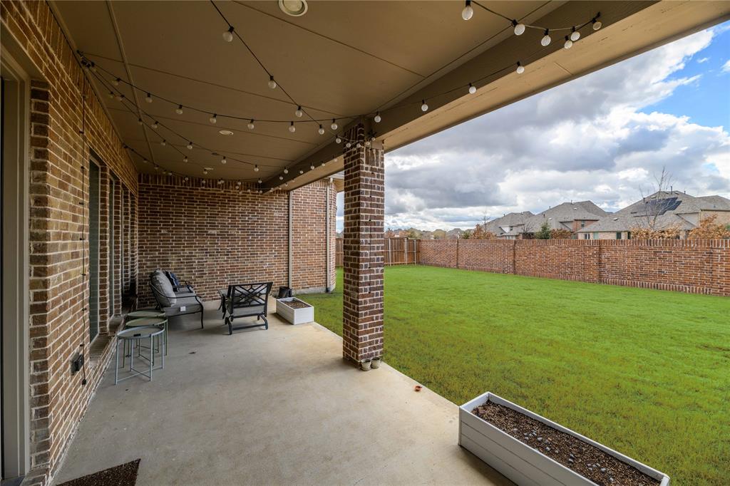 16541 Sweetgum Road Frisco, TX 75033 - Photo 23 of 26 Spacious covered patio featuring string lighting, a concrete surface, and brick pillars