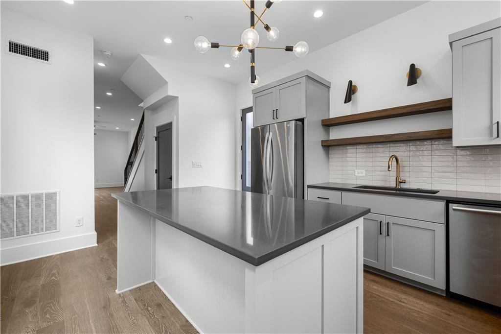 255 High Street Fayetteville, GA 30214 - Photo 12 of 67 a kitchen with stainless steel appliances granite countertop a sink a refrigerator and a stove top oven