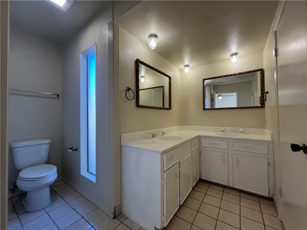 5002 Wingfoot Lane, Unit A Corpus Christi, TX 78413 - Photo 12 of 25 a bathroom with a toilet sink and mirror