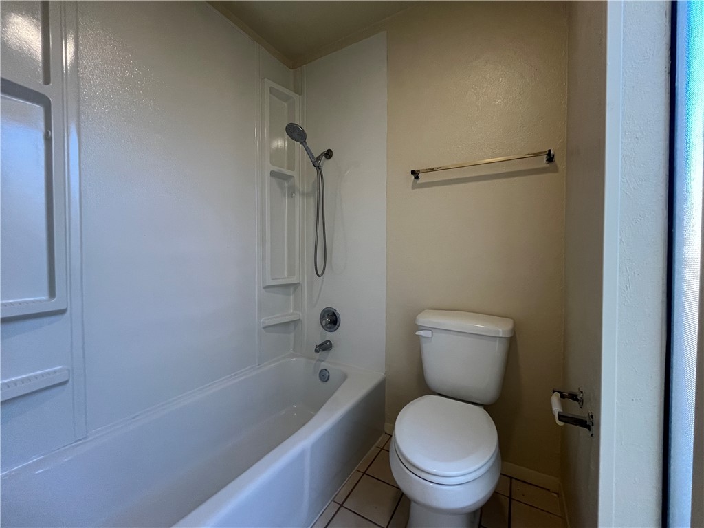 5002 Wingfoot Lane, Unit A Corpus Christi, TX 78413 - Photo 13 of 25 a white toilet sitting next to a bath tub