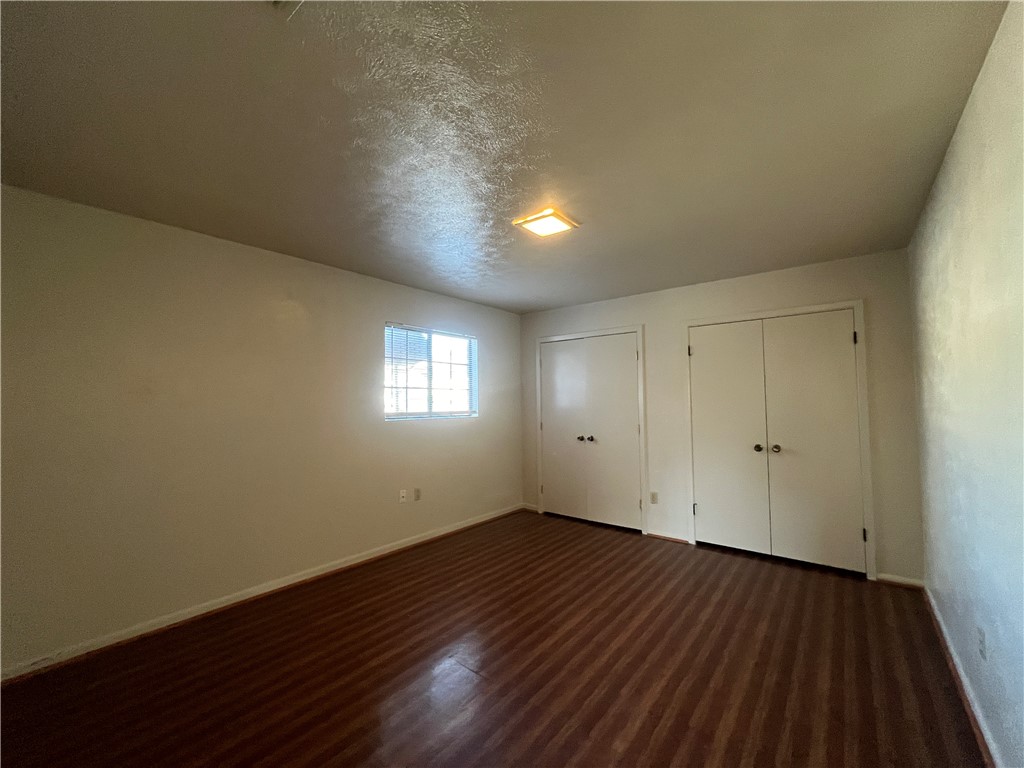 5002 Wingfoot Lane, Unit A Corpus Christi, TX 78413 - Photo 20 of 25 an empty room with wooden floor and windows