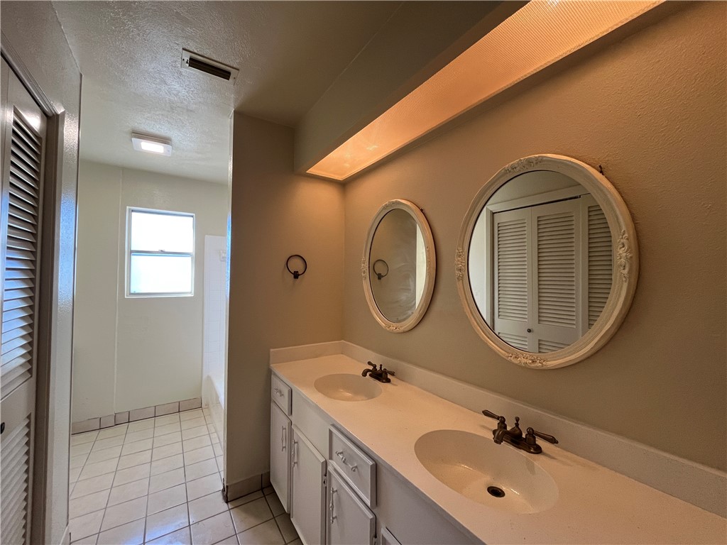 5002 Wingfoot Lane, Unit A Corpus Christi, TX 78413 - Photo 22 of 25 a bathroom with a sink and a mirror