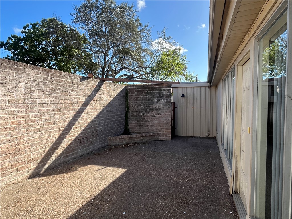 5002 Wingfoot Lane, Unit A Corpus Christi, TX 78413 - Photo 4 of 25 a backyard of a house with lots of green space