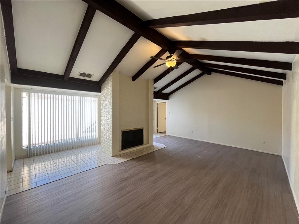5002 Wingfoot Lane, Unit A Corpus Christi, TX 78413 - Photo 7 of 25 a view of an empty room with wooden floor and windows