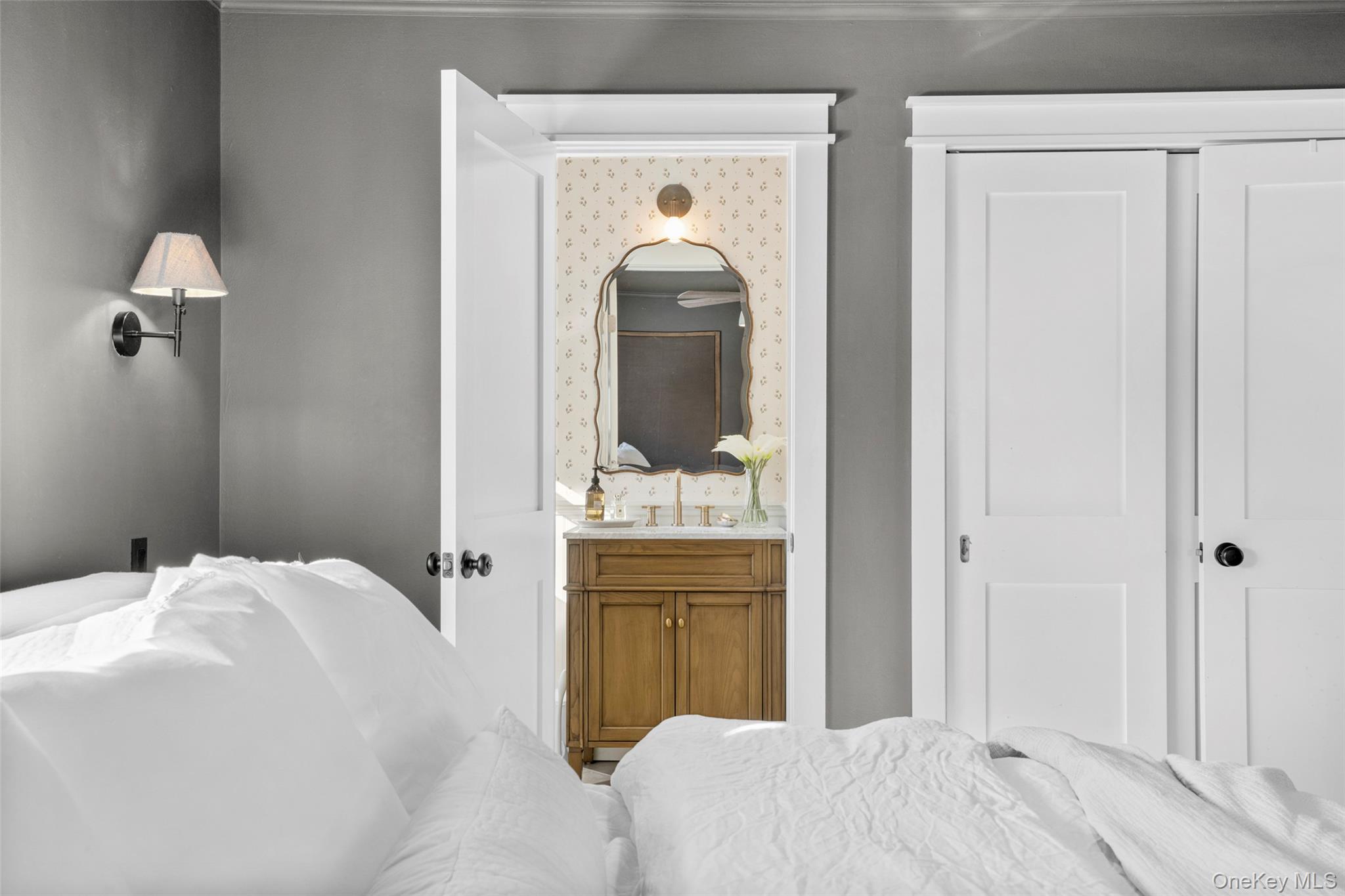 87 Inverness Road New Rochelle, NY 10804 - Photo 16 of 29 View across primary bedroom into ensuite 1/2 bath