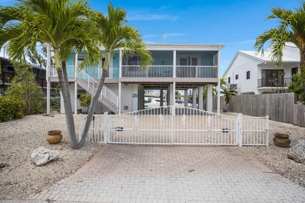 a view of a house with a wooden fence