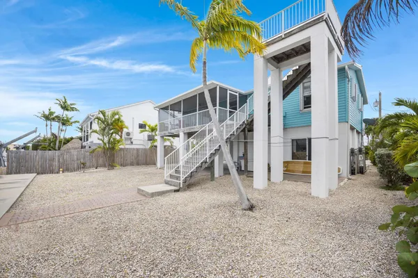 a view of a hallway with wooden floor and windows