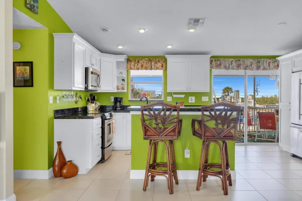 a kitchen with a table chairs and a view of living room