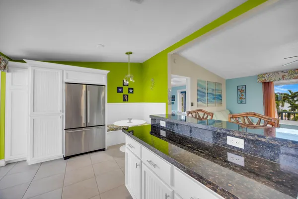 a large kitchen with stainless steel appliances granite countertop a sink and cabinets