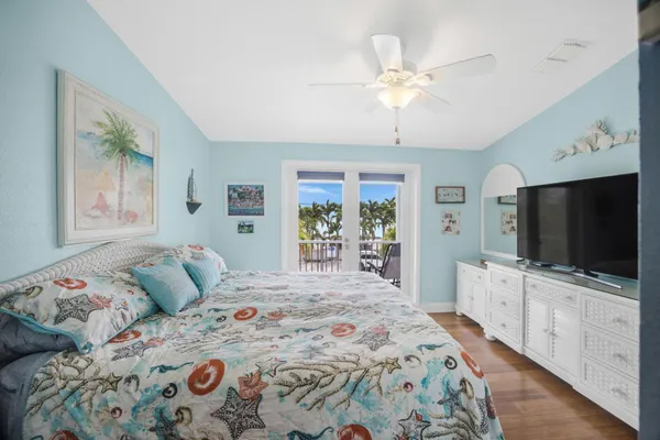 a bedroom with a bed and a flat screen tv in it