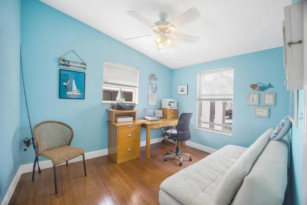 a dining room with furniture and wooden floor
