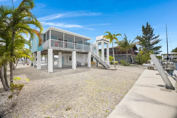 a backyard of a house with palm trees