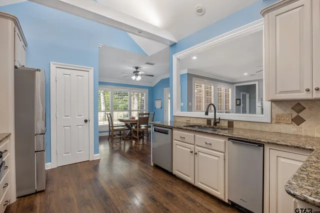 a kitchen with lots of counter top space and dining table