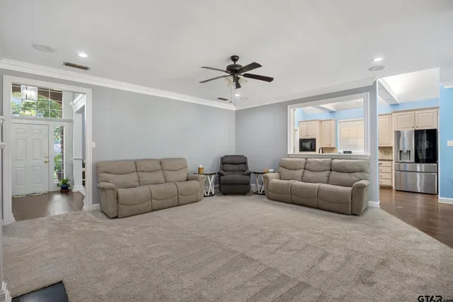 a living room with furniture and kitchen view