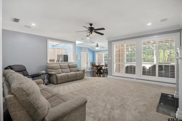 a living room with furniture and large windows