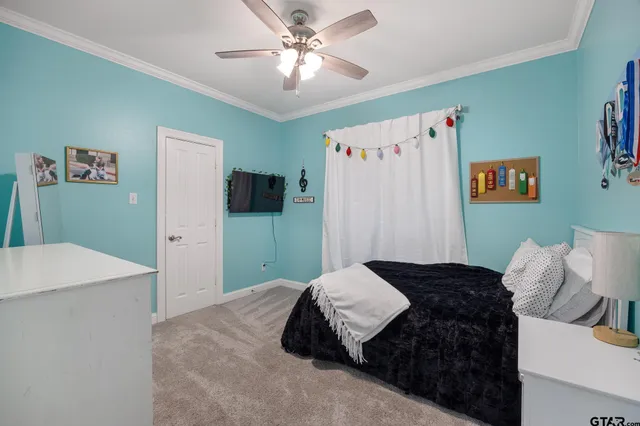 a bedroom with a bed and a refrigerator