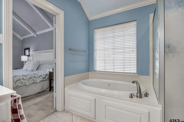 a en suite bathroom with a bathtub and window