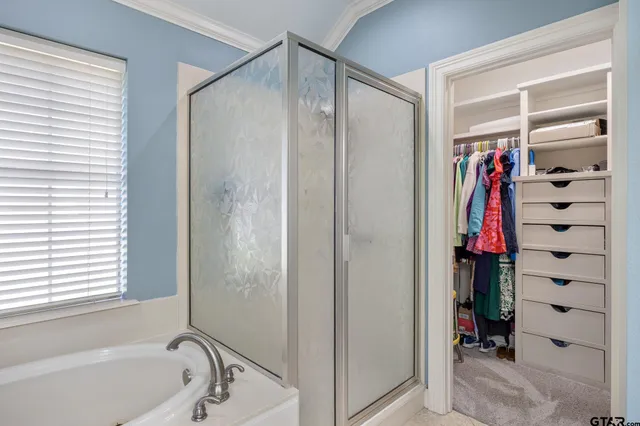 a bathroom with a shower and a tub