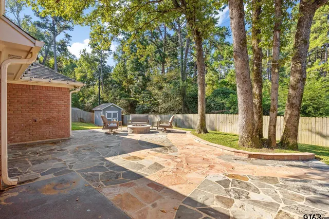 a view of a backyard with large trees