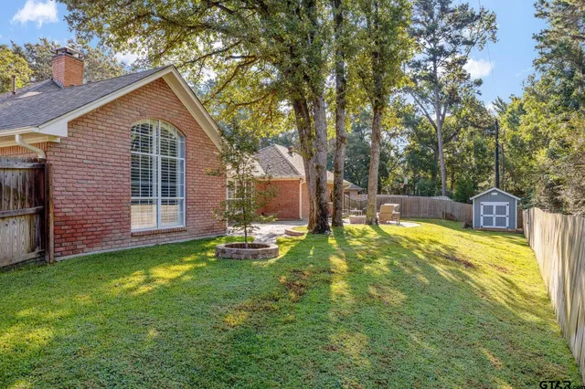 a view of a house with a yard and sitting area