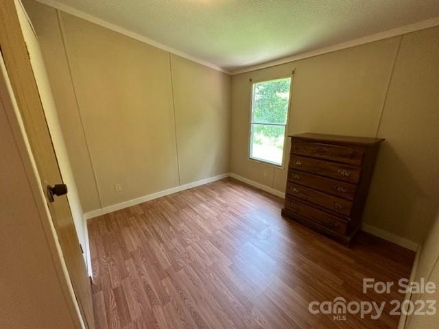 143 Hubert McCall Drive Balsam Grove, NC 28708 - Photo 14 of 19 a view of room with window and hardwood floor