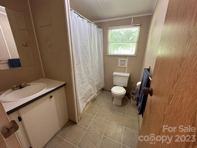 143 Hubert McCall Drive Balsam Grove, NC 28708 - Photo 15 of 19 a bathroom with a sink a toilet and a window