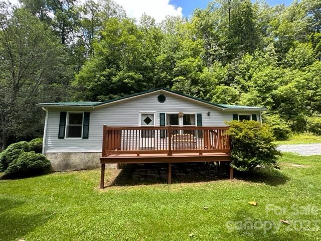 143 Hubert McCall Drive Balsam Grove, NC 28708 - Photo 19 of 19 a view of a house with a yard deck and a small yard