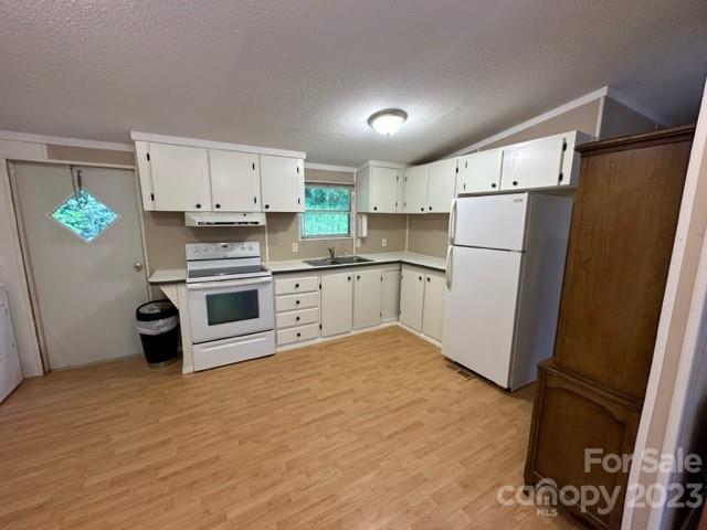 143 Hubert McCall Drive Balsam Grove, NC 28708 - Photo 7 of 19 a kitchen with white cabinets and white appliances