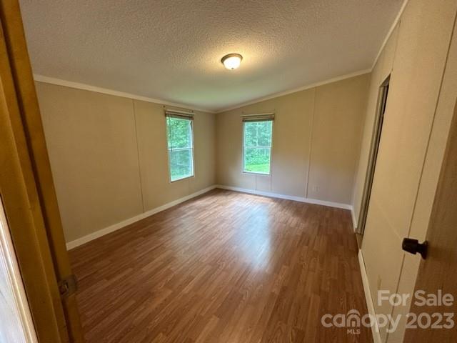 143 Hubert McCall Drive Balsam Grove, NC 28708 - Photo 10 of 19 a view of an empty room with wooden floor and a window