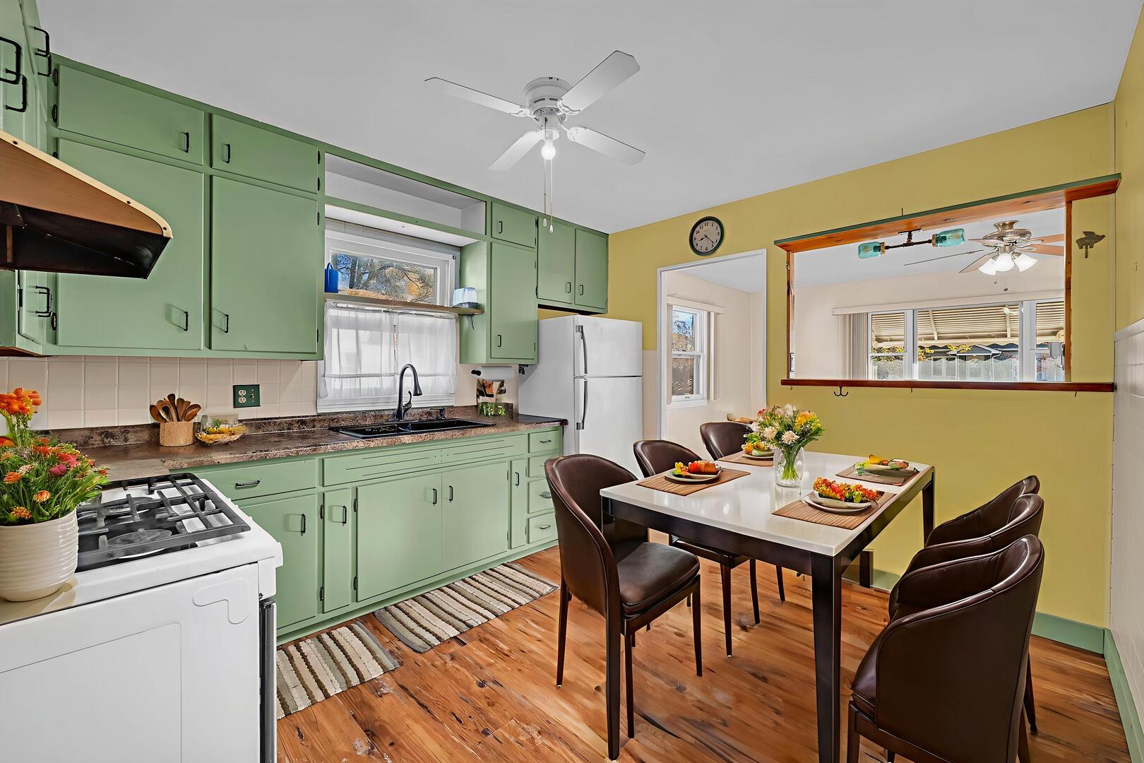 711 Clinton Street Lockport, IL 60441 - Photo 6 of 22 a kitchen with a table chairs stove and cabinets