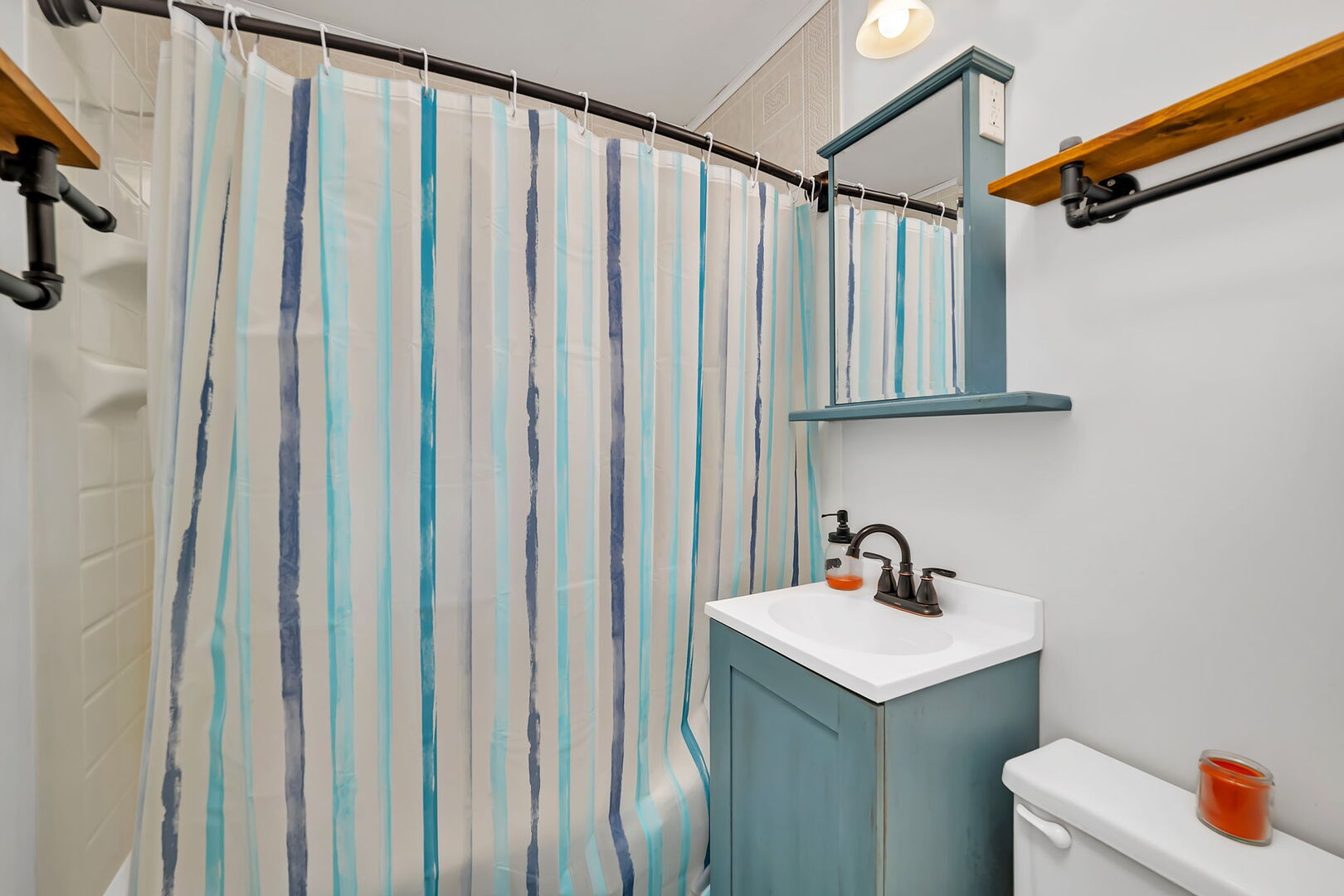 711 Clinton Street Lockport, IL 60441 - Photo 10 of 22 a bathroom with a sink a mirror and shower curtain