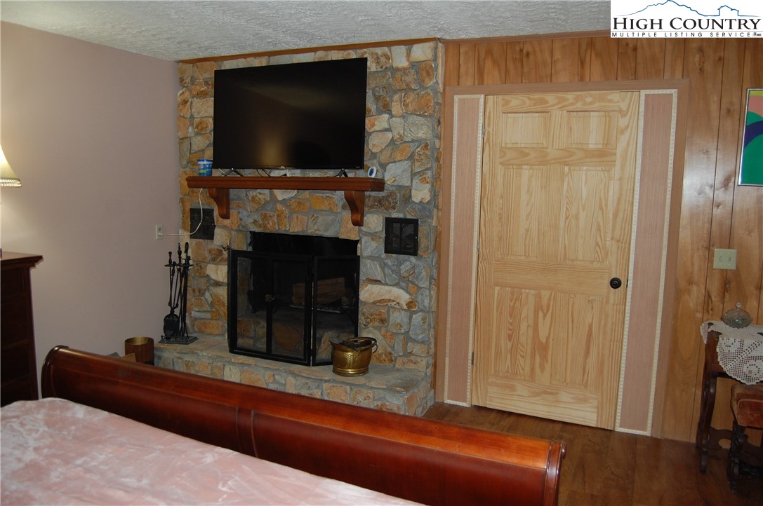 114 Lady Slipper Loop Newland, NC 28657 - Photo 30 of 50 a living room with fireplace and a flat screen tv
