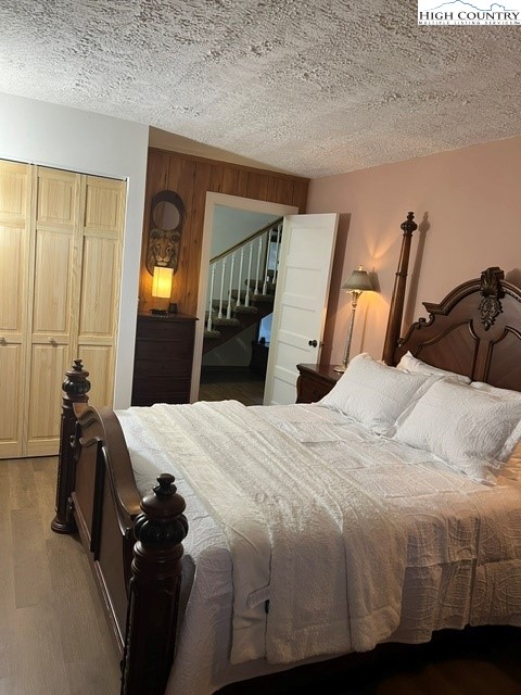 114 Lady Slipper Loop Newland, NC 28657 - Photo 36 of 50 a bedroom with a bed and wooden floor