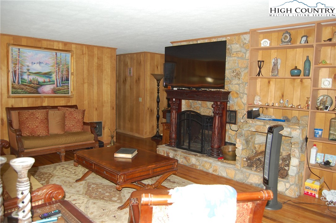 114 Lady Slipper Loop Newland, NC 28657 - Photo 8 of 50 a living room with furniture a flat screen tv and a fireplace