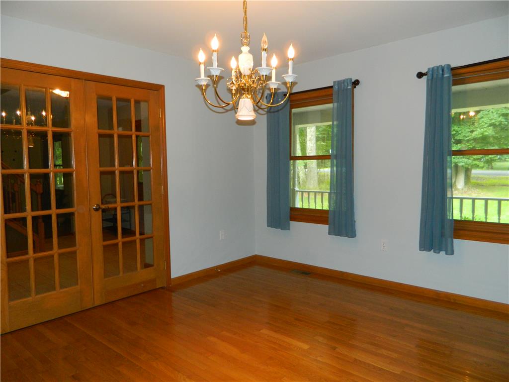 328 Pin Oak Road Stroudsburg, PA 18360 - Photo 12 of 42 Hardwood flooring extends throughout this light-filled room, featuring elegant French doors and charming window views.