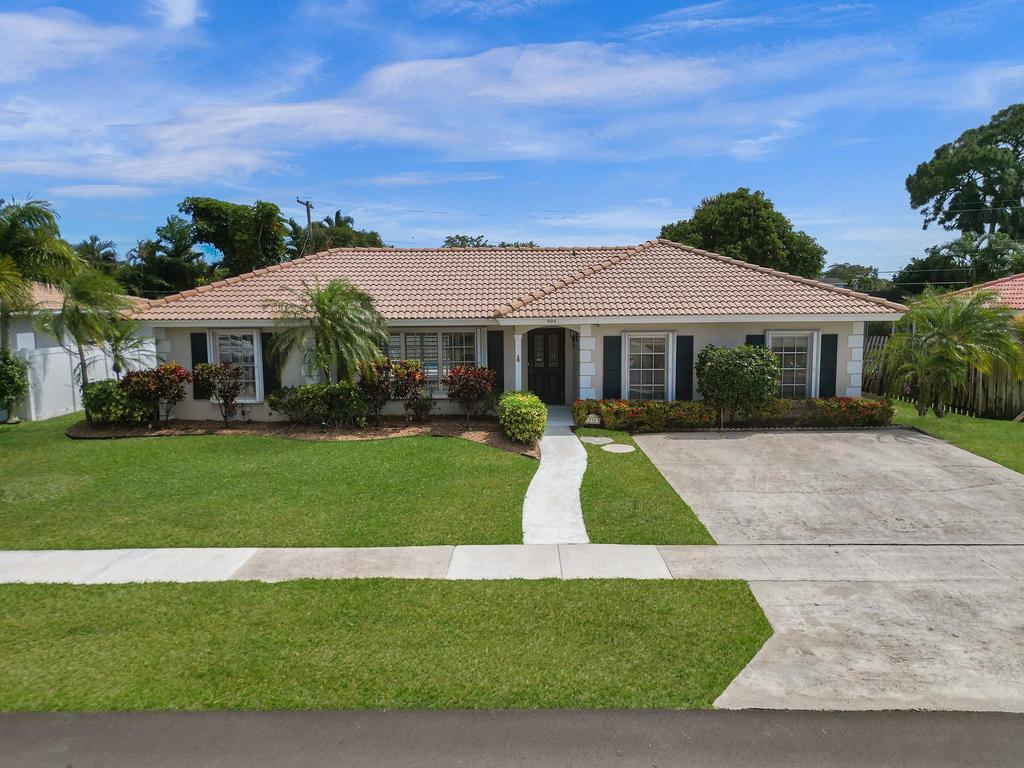 998 Southwest 5th Street Boca Raton, FL 33486 - Photo 1 of 55 a front view of a house with a yard