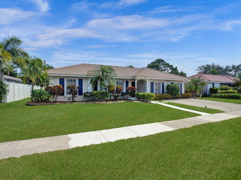 998 Southwest 5th Street Boca Raton, FL 33486 - Photo 11 of 55 a front view of a house with a yard table and chairs