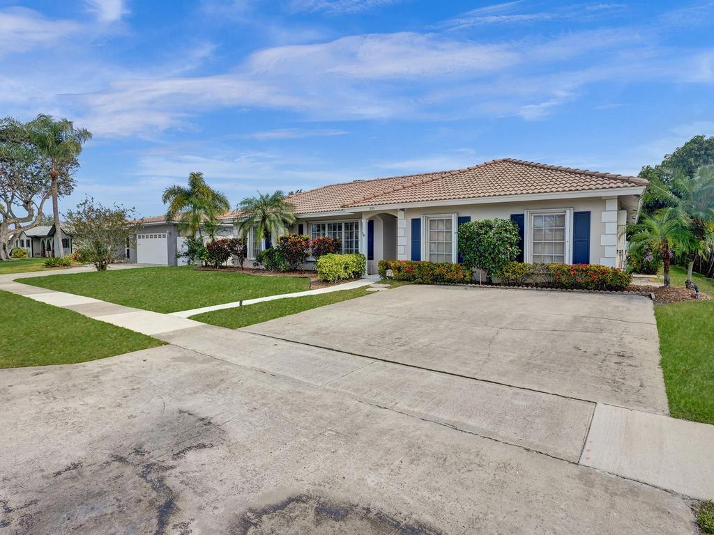 998 Southwest 5th Street Boca Raton, FL 33486 - Photo 13 of 55 a front view of house with yard and green space
