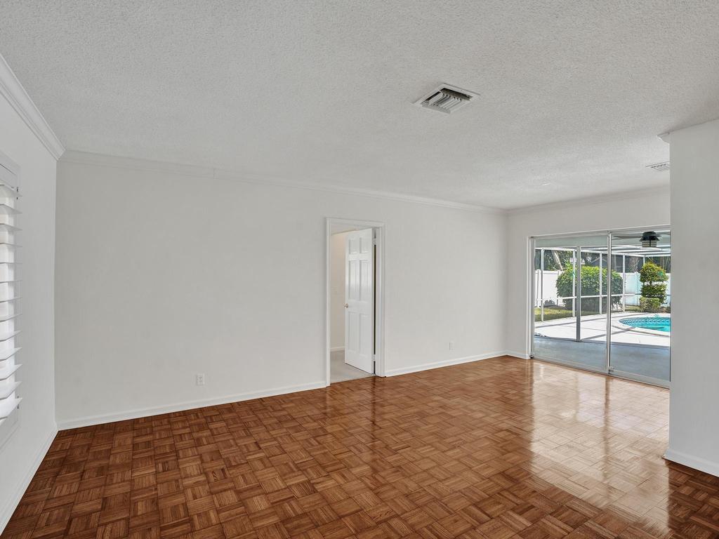 998 Southwest 5th Street Boca Raton, FL 33486 - Photo 18 of 55 a view of empty room with wooden floor and fan
