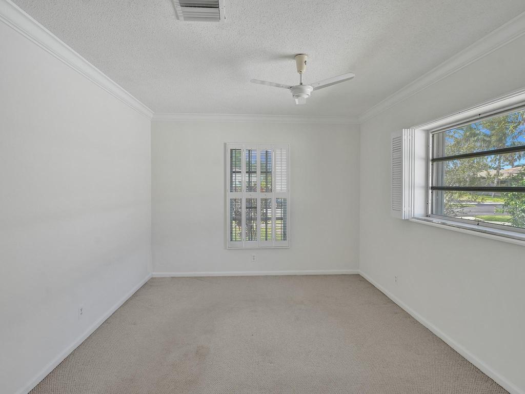 998 Southwest 5th Street Boca Raton, FL 33486 - Photo 23 of 55 an empty room with a window and ceiling fan
