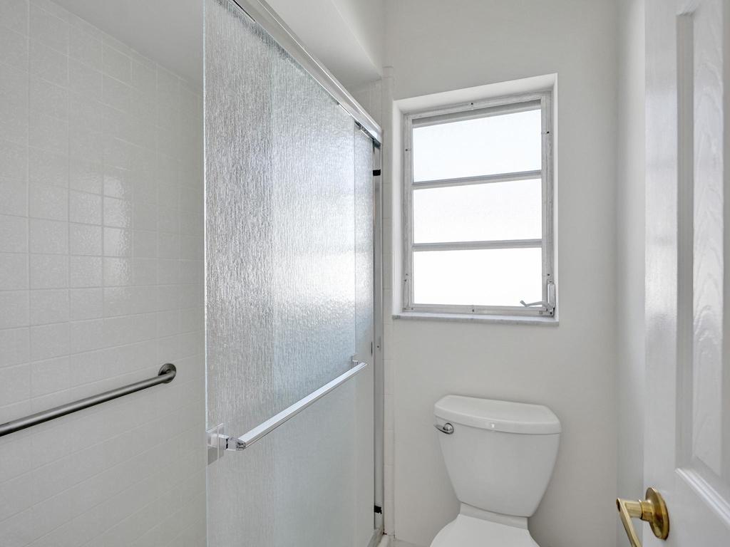 998 Southwest 5th Street Boca Raton, FL 33486 - Photo 26 of 55 a bathroom with a toilet a sink and a window